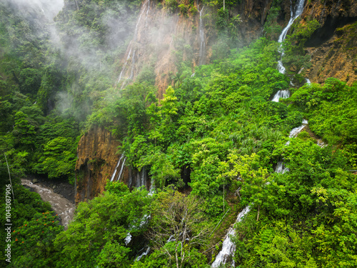 Aerial view of a magnificent waterfall in a lush forest