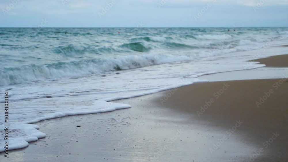 Beautiful sandy beach with water. Sand absorbs sea waves. Sea wave approaches the shore. Beautiful sandy beach with water. Sand absorbs sea waves. Sea wave approaches the shore.