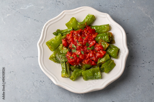 Fried green peppers with tomato sauce - Turkish name; Domates soslu biber kizartmasi photo