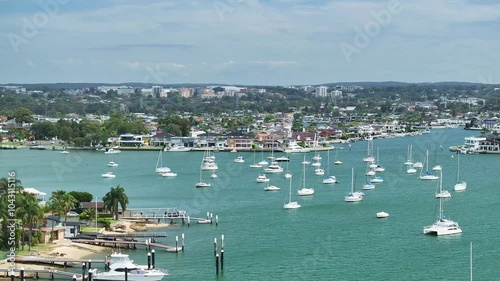 Aerial of yachts and motor boats at Sans Souci in Sydney with luxury houses beyond photo