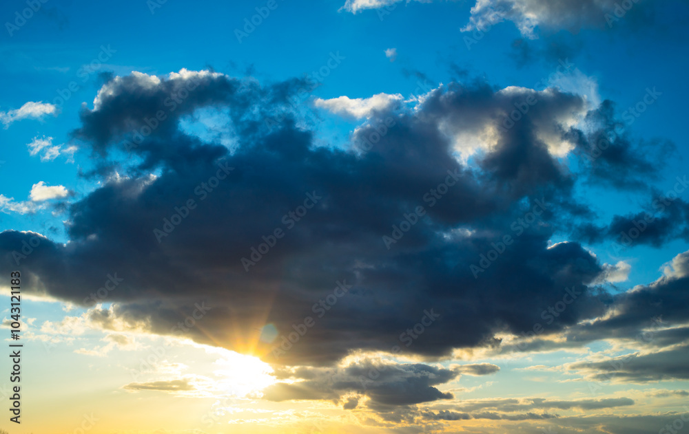 Fototapeta premium Dark clouds and sun at sunset