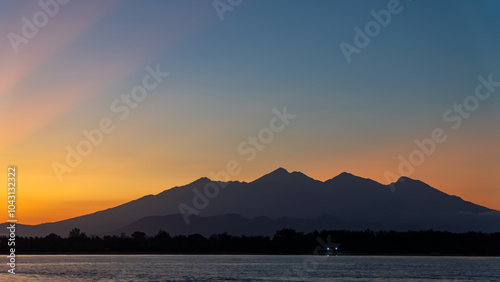 A dusk afterglow over a highland lake with mountains in the background