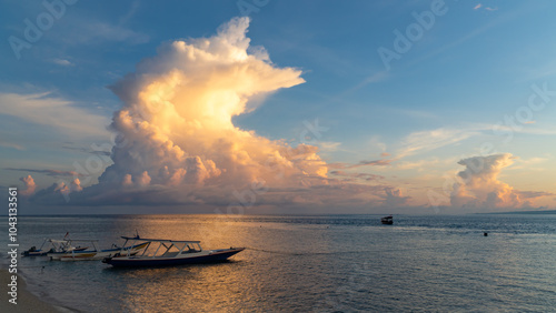 A small boat is gently floating atop a calm body of water