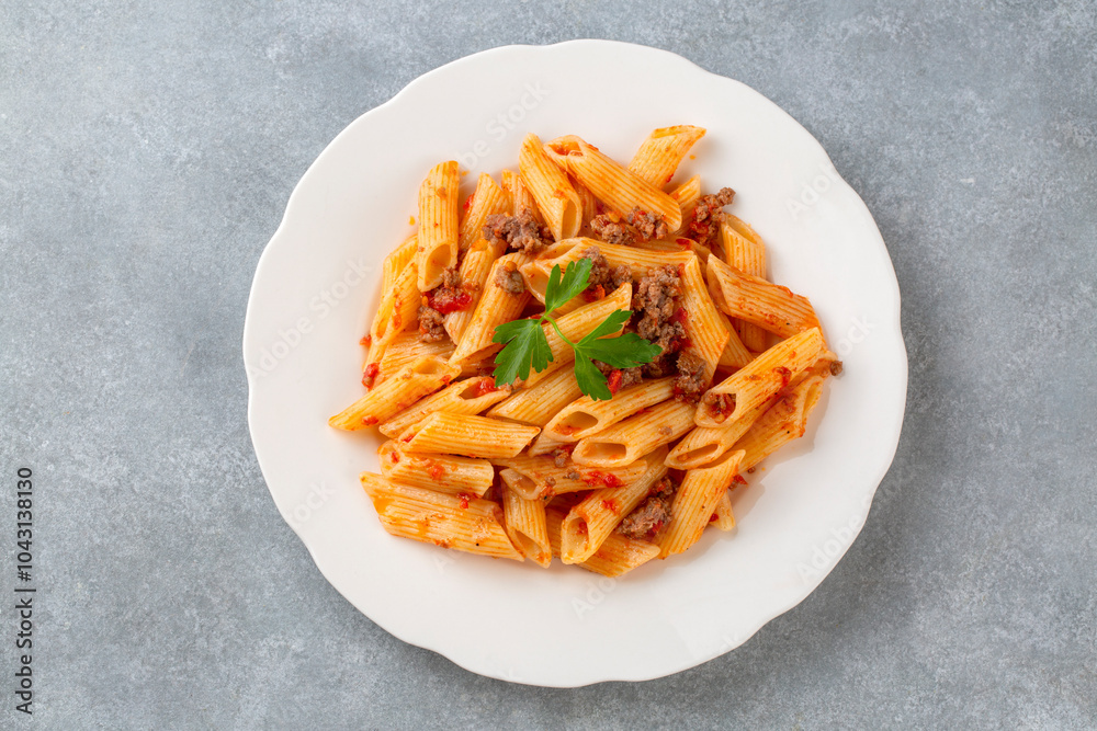 Penne pasta with minced meat and tomato sauce