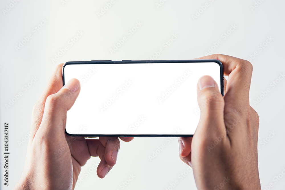 Hand holding mobile phone with white blank screen mockup for playing game screen Hand holding mobile phone with white blank screen mockup for playing game screen