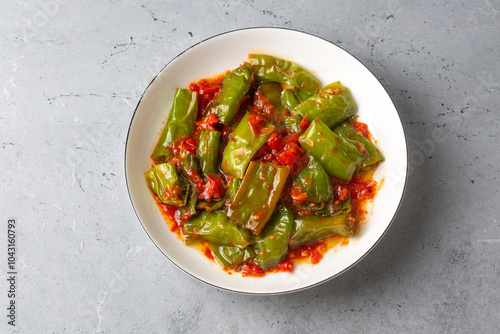 Fried green peppers with to...