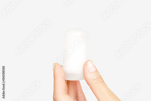 female hand holding mineral potassium alum crystal stick. natural deodorants concept photo