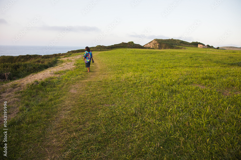 Hiker journeying along a beautiful rural path in Asturias, Spain Hiker journeying along a beautiful rural path in Asturias, Spain