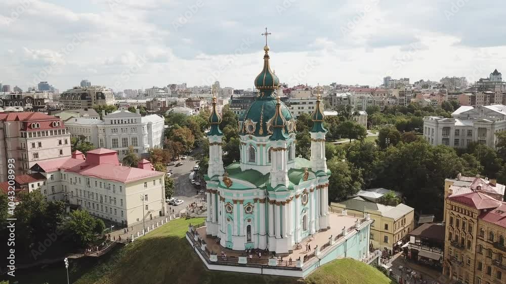 Ukraine, Kyiv's famous St.Andrew Church's drone footage on a summer day with cloudy skies. Footage turns around the church from a perfect angle, footage ends towards to the Dnipro River and bridges. Ukraine, Kyiv's famous St.Andrew Church's drone footage on a summer day with cloudy skies. Footage turns around the church from a perfect angle, footage ends towards to the Dnipro River and bridges.