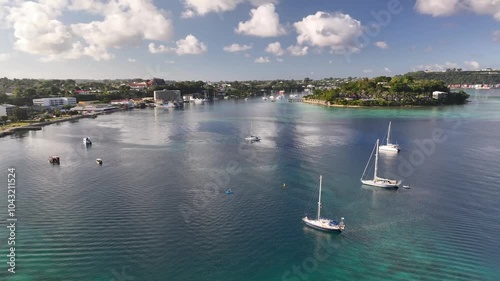 Port Vila, Efate, Vanuatu - A Coastal Tropical City With Boats and Yachts Anchored in the Harbor Beneath a Sky Filled With Fluffy Clouds - Aerial Drone Shot photo