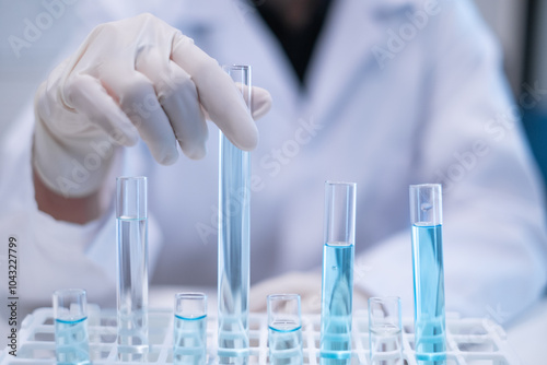 Closeup test tube equipment filling with blue liquid in laboratory room use for science chemistry biology biotechnology medical medicine biochemistry research and development discovery education