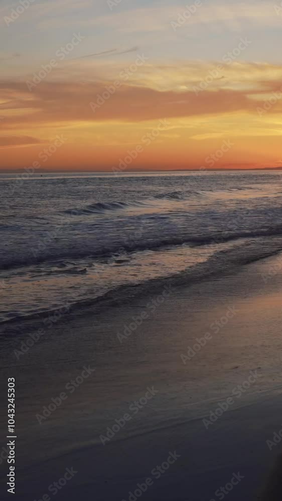 Gentle ocean waves washing ashore during a golden hour sunset, with soft pastel hues in the sky and water reflections creating a serene scene Gentle ocean waves washing ashore during a golden hour sunset, with soft pastel hues in the sky and water reflections creating a serene scene