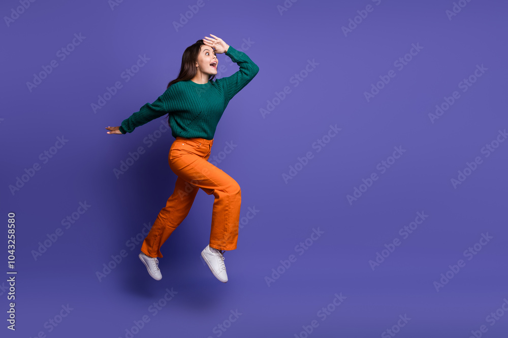 Full length portrait of nice young girl jump run empty space ad isolated on violet color background