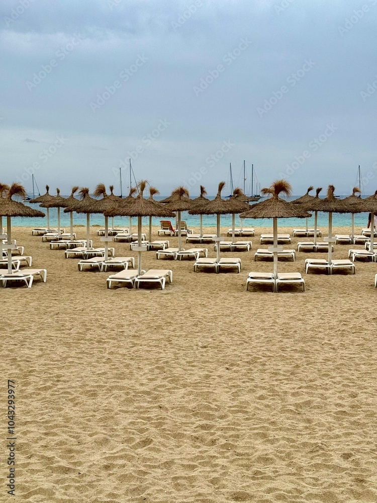 Beach with umbrellas and sun loungers. Palma de Mallorca 2024 Beach with umbrellas and sun loungers. Palma de Mallorca 2024