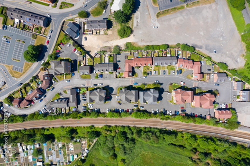 Top down aerial photo of a typical British housing estate along side a train track located in the village of Pontefract in Wakefield, West Yorkshire in the UK on a sunny summers day photo