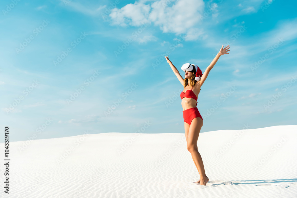 A joyful woman in swimwear celebrates Christmas on a sunny beach with a festive Santa hat A joyful woman in swimwear celebrates Christmas on a sunny beach with a festive Santa hat