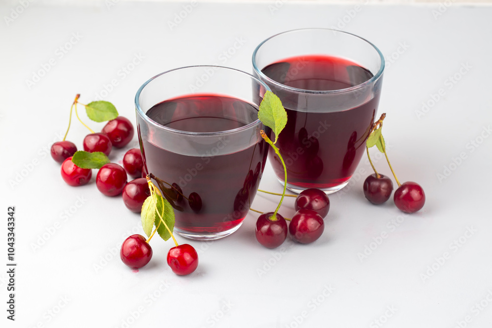 Glass of sour cherry juice with fresh red cherries, summer juice