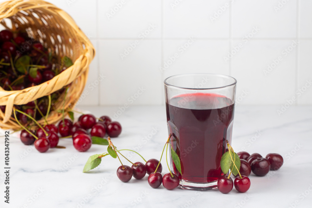 Glass of sour cherry juice with fresh red cherries, summer juice