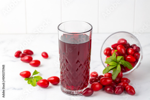 Glass of healthy dogwood berry drink on light background. Turkish name; Kizilcik serbeti photo