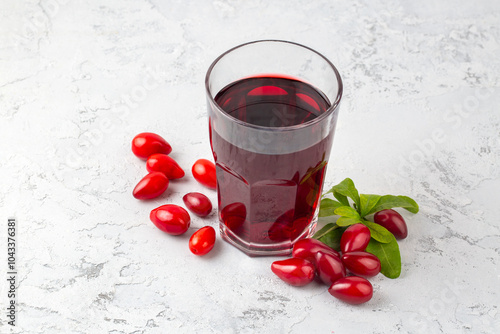 Glass of healthy dogwood berry drink on light background. Turkish name; Kizilcik serbeti photo