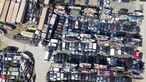 Aerial view of the large junk yard with various cars, trucks, vans and boats. Located in southern Spain, Malaga province, Cartama.
