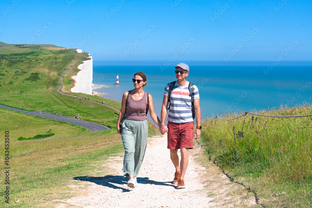 A couple hiking the Seven Sisters Cliffs