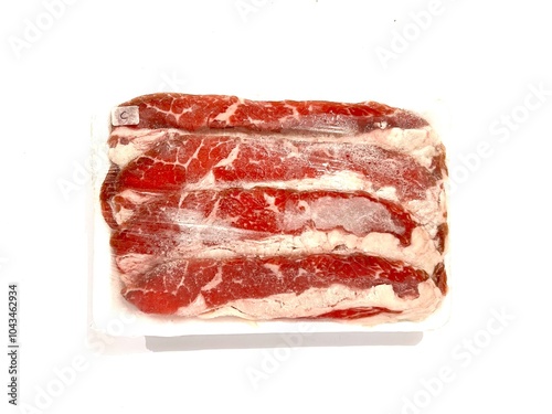 Pack of frozen fresh and raw red beef slice with fat in plastic wrap isolated on white background