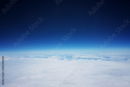 Low earth orbit - View of white clouds and mountains during the flight to the low orbit of the Earth, at the top of the blue sky and space photo