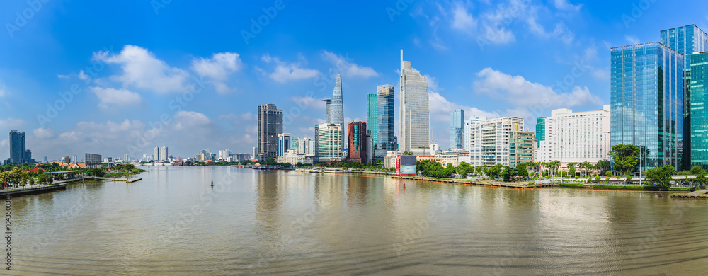 Fototapeta premium Panorama of Ho Chi Minh City, Vietnam seen from the other side of the Saigon River. This is the largest city and has the largest economy in Vietnam and is located in the south of the country.