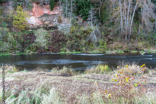 rapid flow of a wild river, blurred water surface, autumn in nature, Braslas river photo