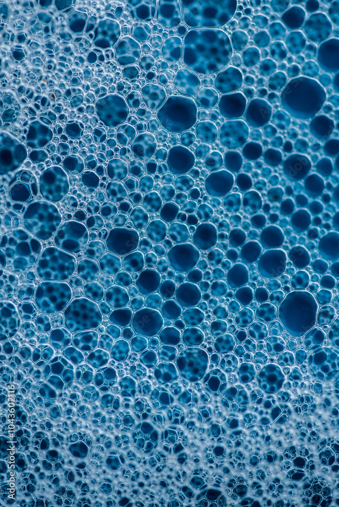 Background and pattern. White soap foam with bubbles, texture on blue tile background. Background and pattern. White soap foam with bubbles, texture on blue tile background.