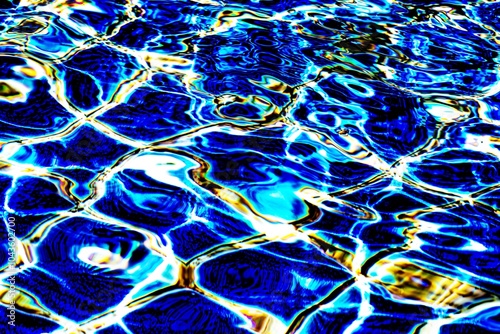 The image is of a body of water with blue and yellow waves. The water appears to be calm and peaceful, with the waves gently lapping against the shore. The colors of the water