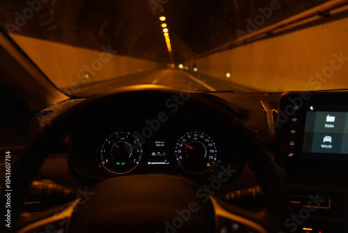 Driver view to the speedometer. Blurred empty tunnel road at night. Madeira island, Portugal.