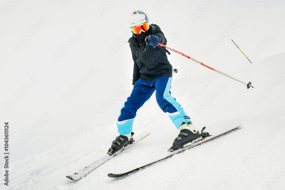 Young man learning to ski on a snowy slope having fun point finger to at camera while slowing down on snowy slope isolated Young man learning to ski on a snowy slope having fun point finger to at camera while slowing down on snowy slope isolated