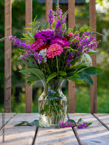 Summer bouquet. Beautiful multi colored fresh flower arrangement. Birthday bouquet made of summer flowers photographed outdoors.