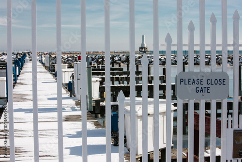 Looking through a pier gate at Port Washington, Wisconsin harbor in winter photo