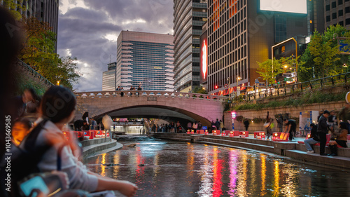 Cheonggyecheon night view with people and lights on after sunset in Seoul, South Korea