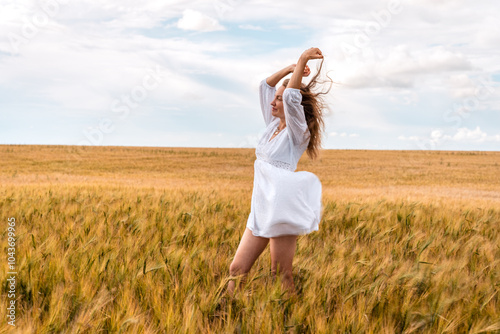 Russia, Republic of Tatarstan, Kalmash village, August 01, 2024, 17:00, girl in a dress in a wheat field in summer