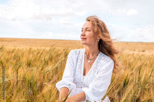 Russia, Republic of Tatarstan, Kalmash village, August 01, 2024, 17:00, girl in a dress in a wheat field in summer photo