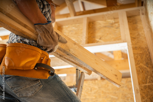Wallpaper Mural Construction Worker Carrying Wooden Beams Inside a Building Under Renovation During the Day Torontodigital.ca
