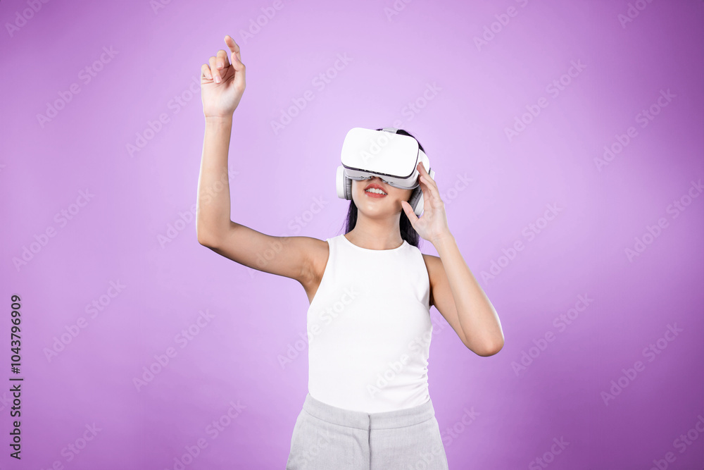 Smart female standing with pink background wearing VR headset connecting metaverse, futuristic cyberspace community technology. Elegant woman excited seeing generated virtual scenery. Hallucination. Smart female standing with pink background wearing VR headset connecting metaverse, futuristic cyberspace community technology. Elegant woman excited seeing generated virtual scenery. Hallucination.