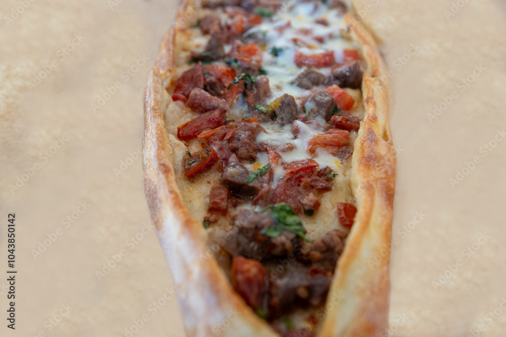 Pita with cheese and cubed meat.