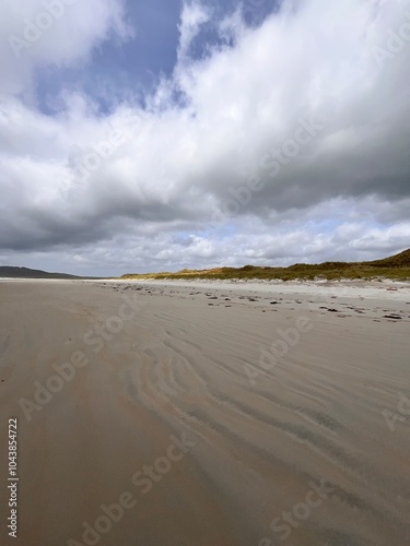 beach and sea with a hint of the rolling hills and sand dunes Ireland co Donegal