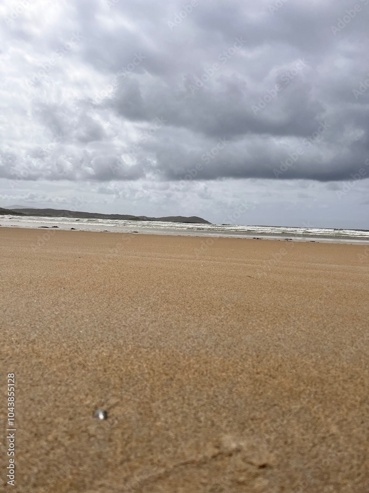 beach and sea with a hint of the rolling hills and sand dunes Ireland co Donegal beach and sea with a hint of the rolling hills and sand dunes Ireland co Donegal