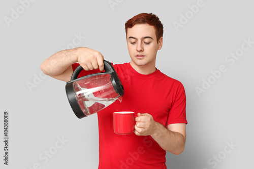 Handsome young man pouring ...