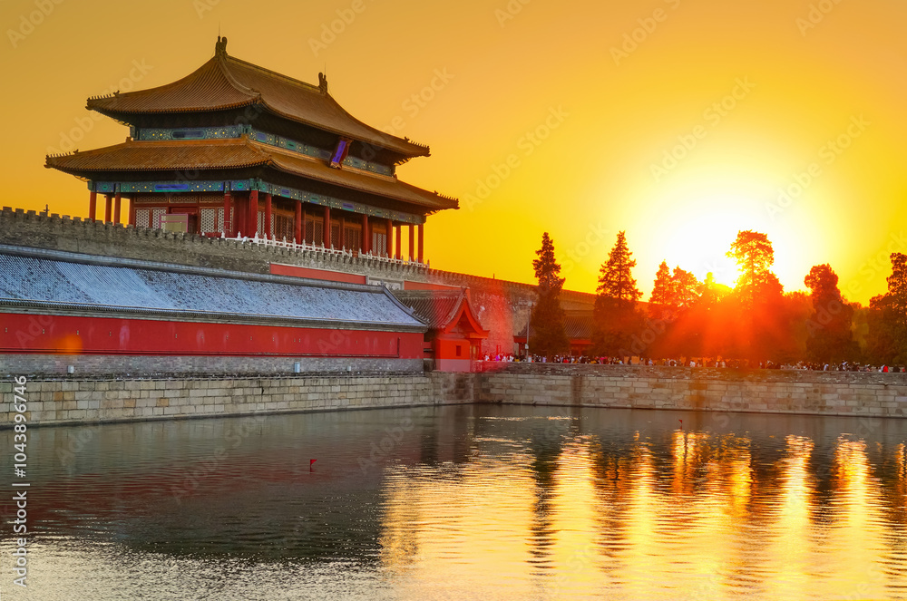 View of the Forbidden City with the reflection on the moat at sunset in Beijing, China. View of the Forbidden City with the reflection on the moat at sunset in Beijing, China.