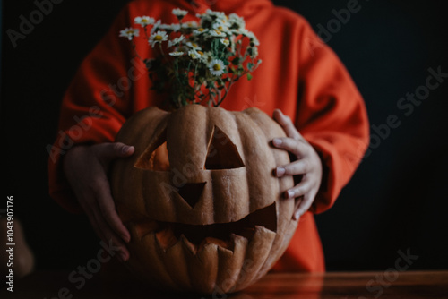 Wallpaper Mural Teenager girl holding carved Halloween pumpkin with flowers inside, close up Torontodigital.ca
