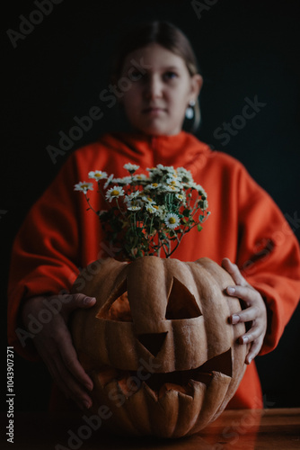 Wallpaper Mural Teenager girl holding carved Halloween pumpkin with flowers inside, close up Torontodigital.ca