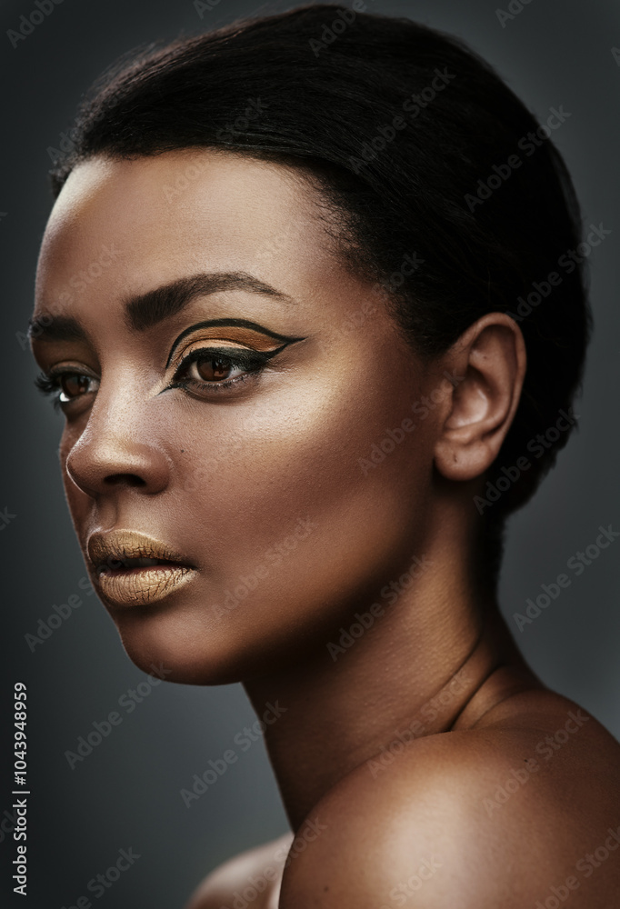 Thinking, makeup and black woman with beauty, glow and gold eyeshadow on face. Model, facial cosmetics and eyeliner for skin, aesthetic or creative art for cat eye isolated on gray studio background Thinking, makeup and black woman with beauty, glow and gold eyeshadow on face. Model, facial cosmetics and eyeliner for skin, aesthetic or creative art for cat eye isolated on gray studio background