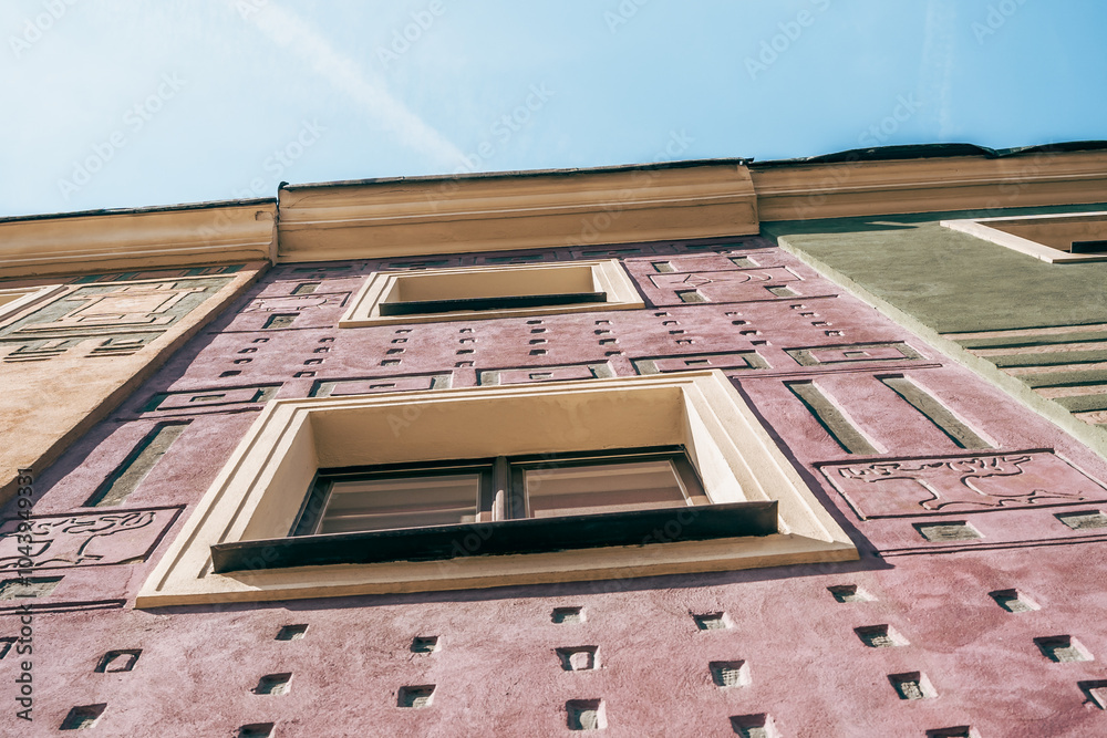 Colorful Historic Buildings and Houses on Stary Rynek Square in Poznań, Poland, with a Blue Sky and Mural Art